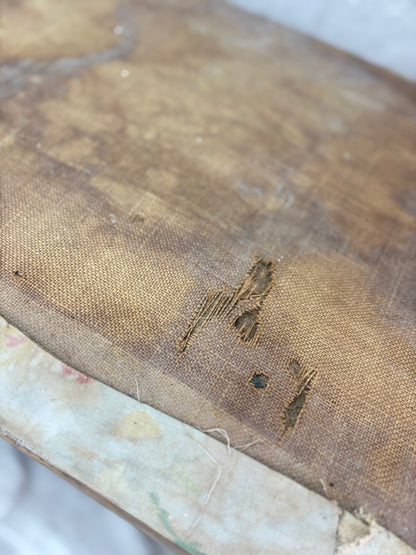 Close-up of an old, worn trunk with visible damage and discoloration.