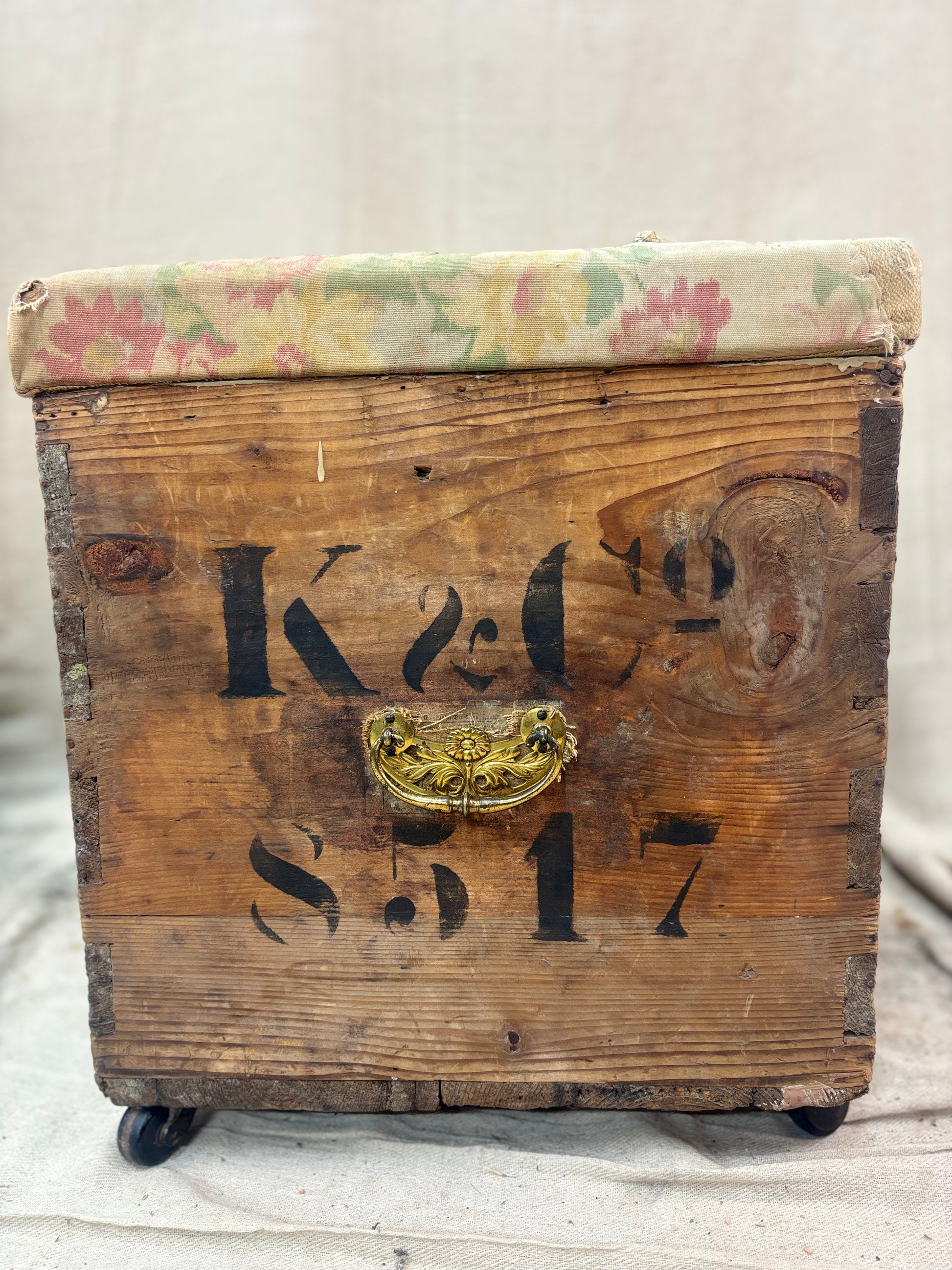 Vintage wooden trunk with floral lid on a neutral background