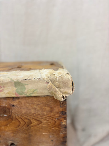 Close-up of an old wooden box with chipped paint on a neutral background