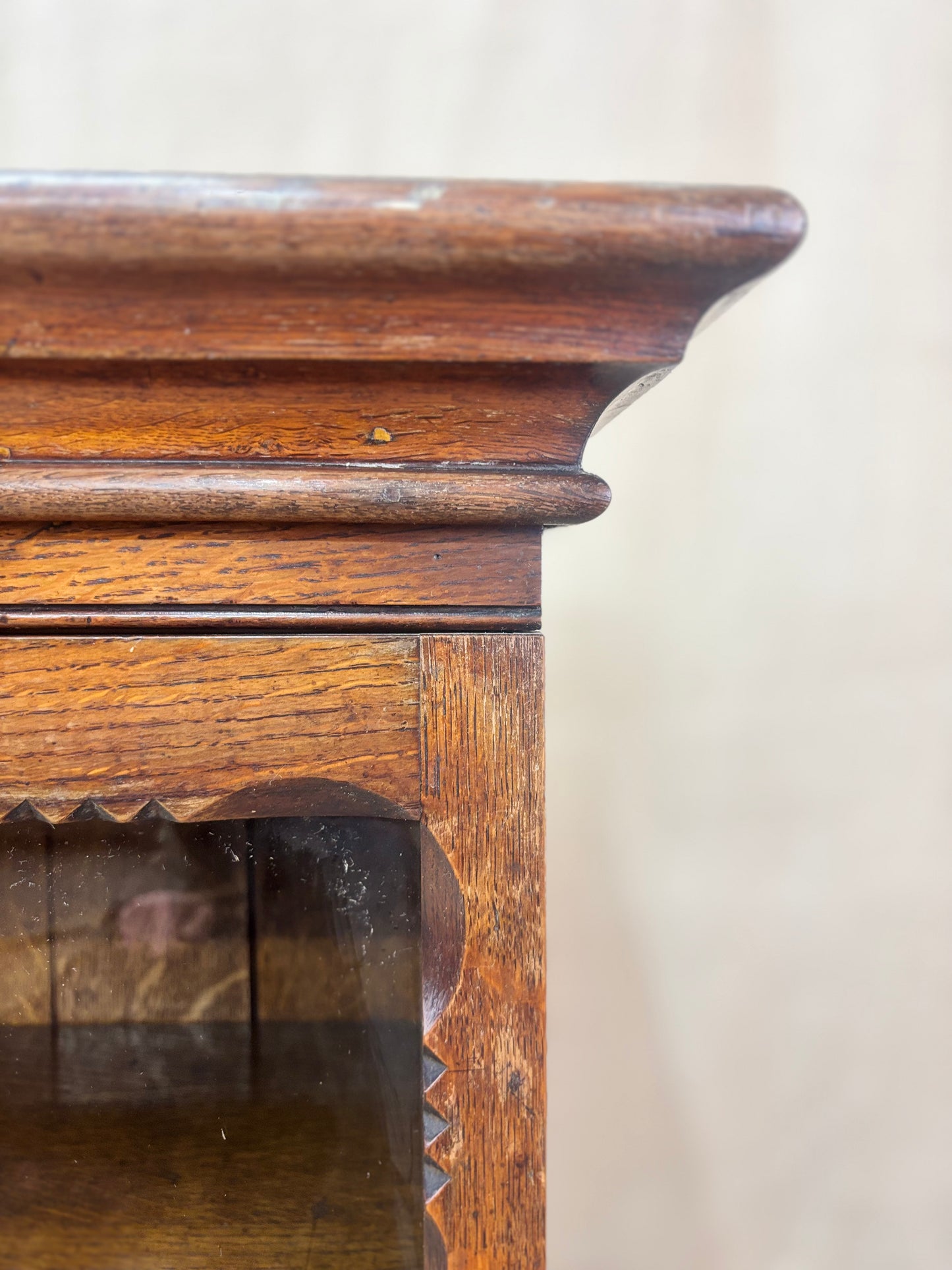 Close-up of a wooden cabinet with glass door on a white background