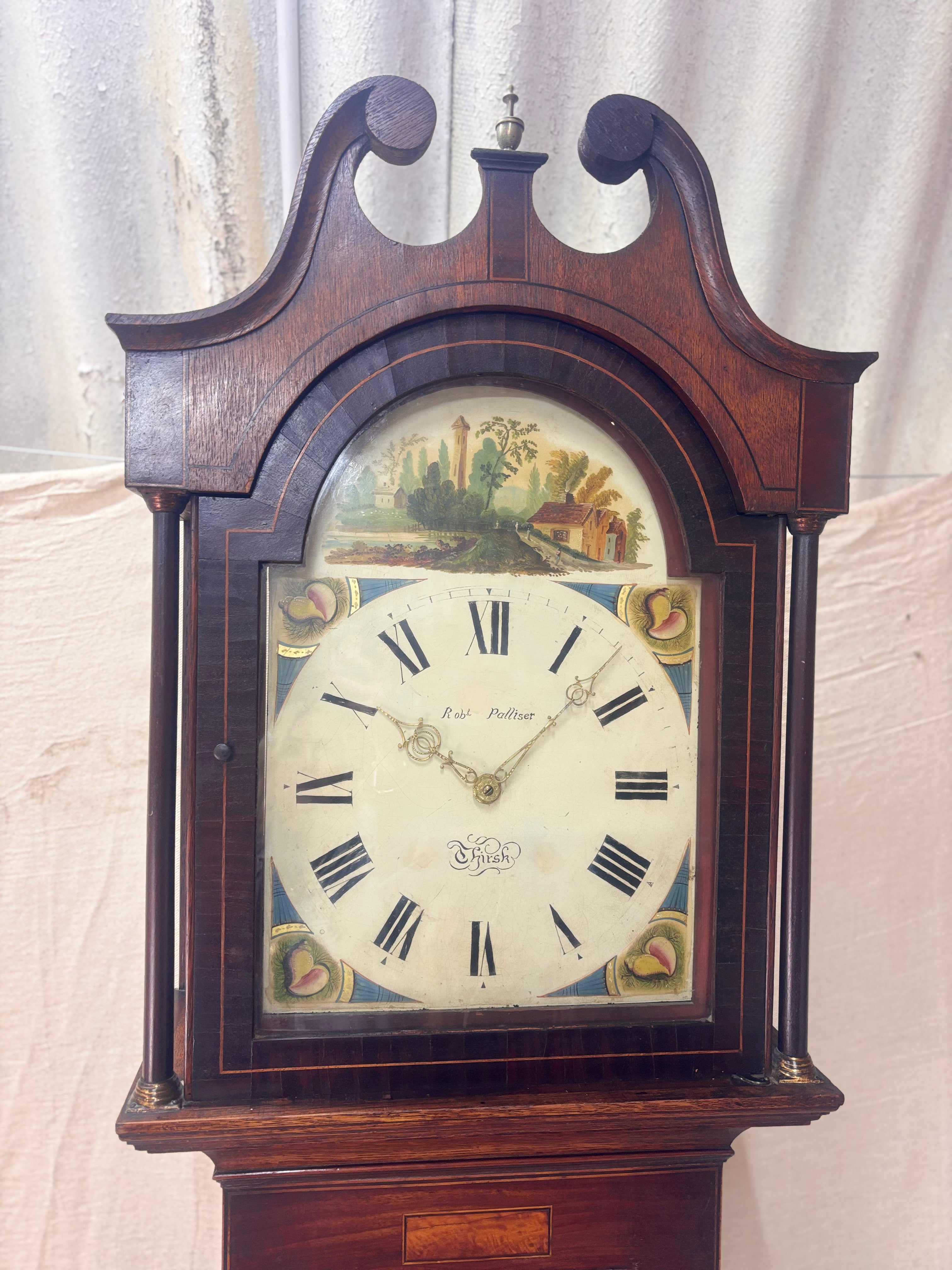 A antique Longbody Clock against a cloth Backdrop