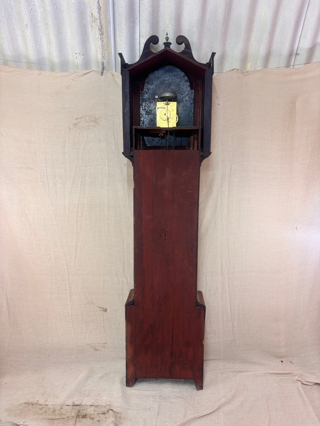 Back of a Grandfather clock against a cloth background