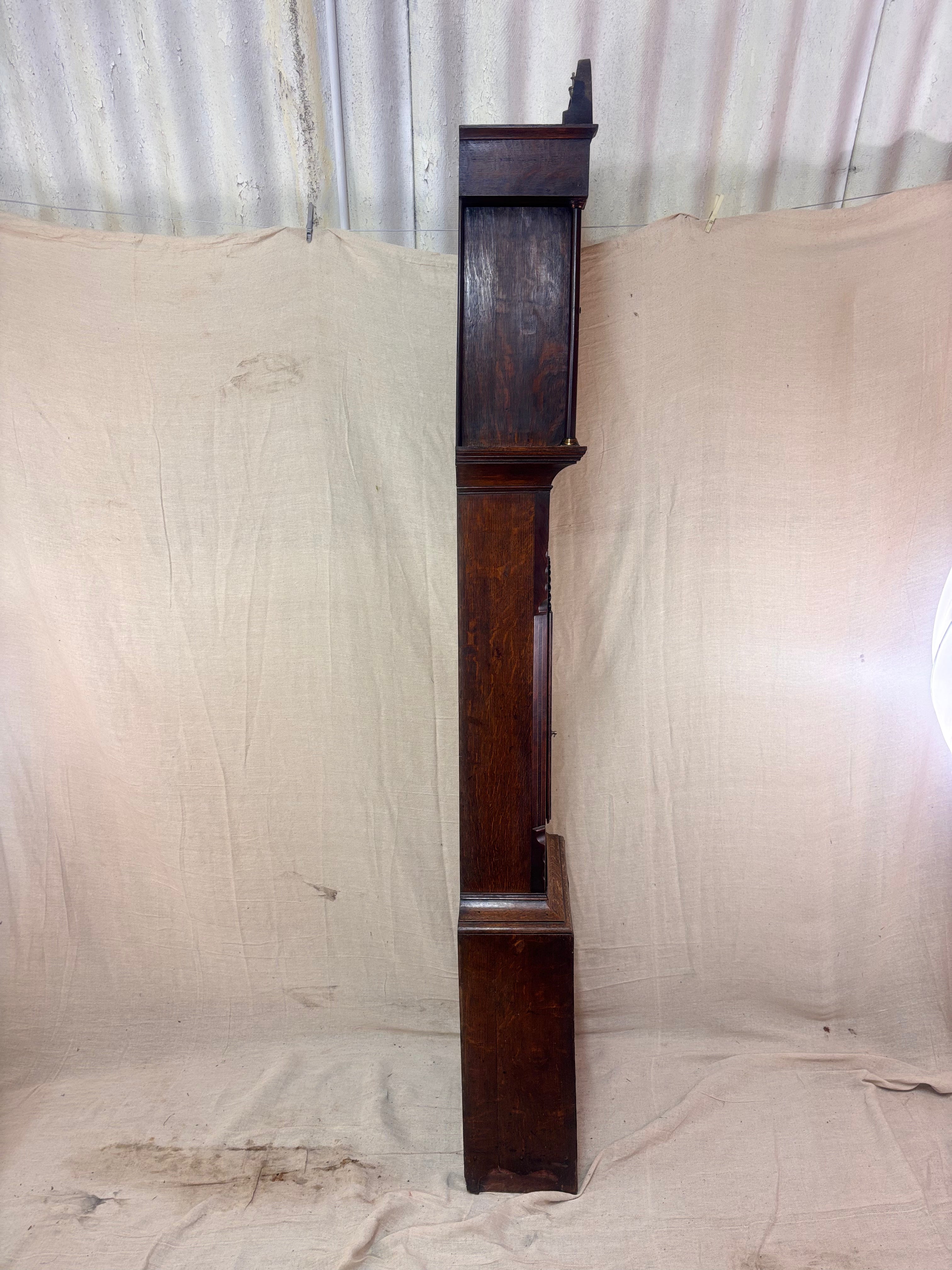 Side of a Grandfather clock against a cloth background