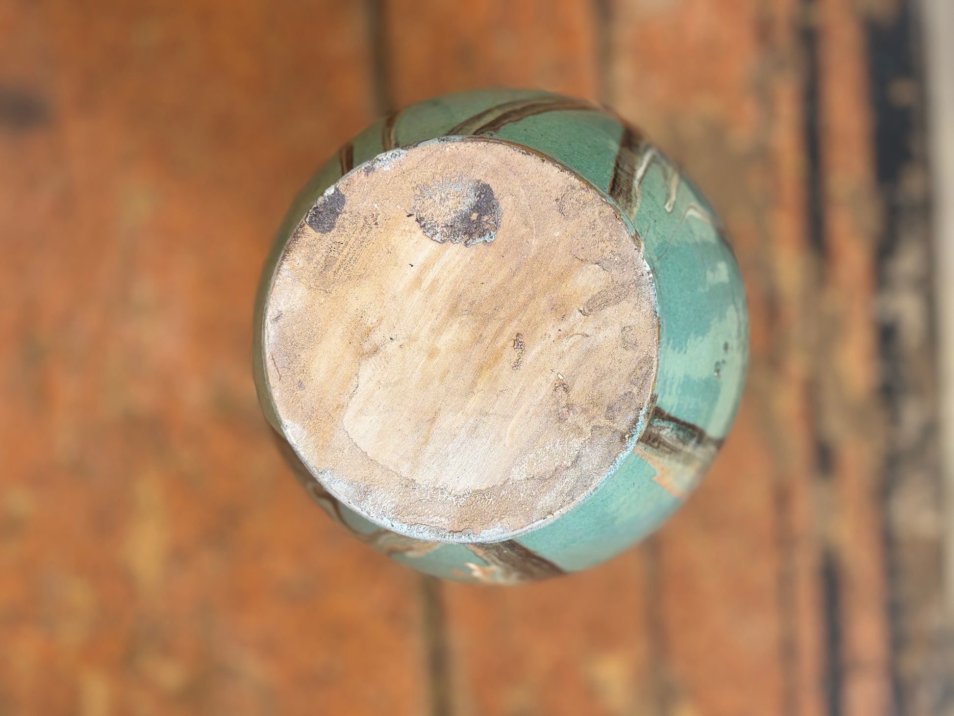 Close-up of a worn wooden knob on a wooden door