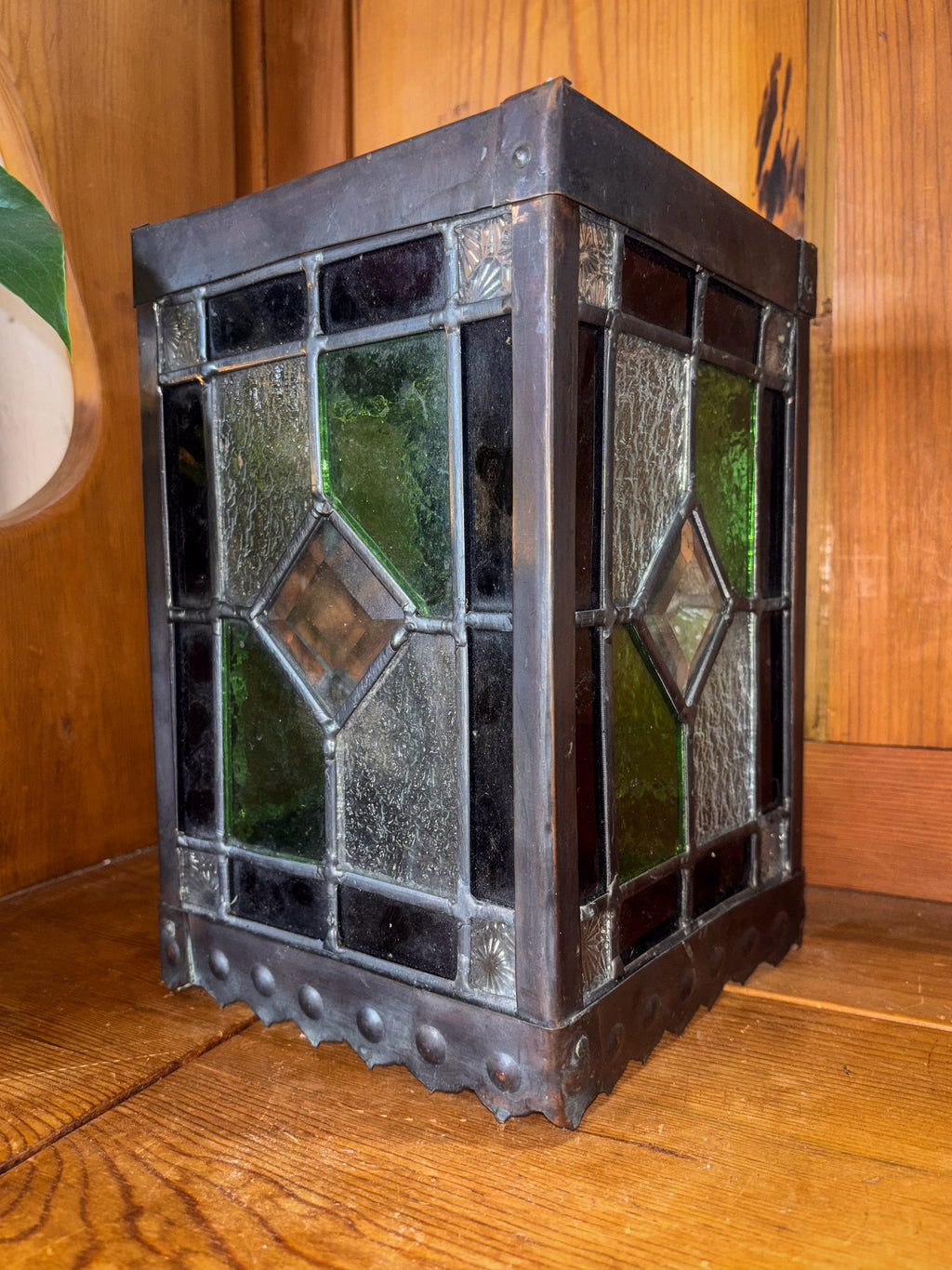 Decorative stained glass lantern on a wooden surface