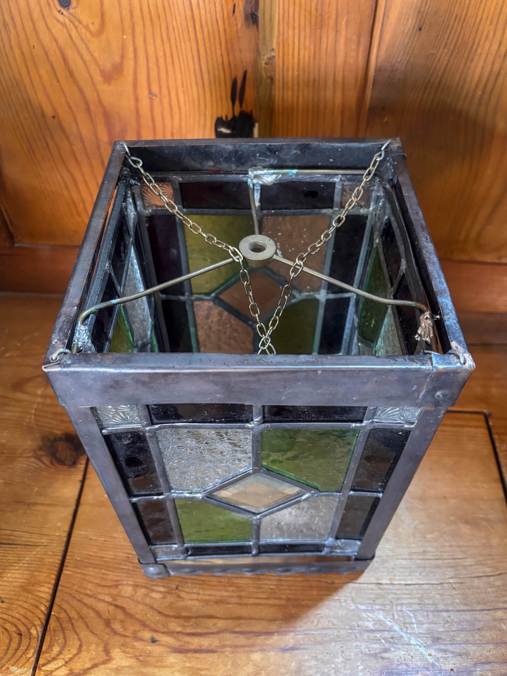 Decorative stained glass lantern on a wooden surface