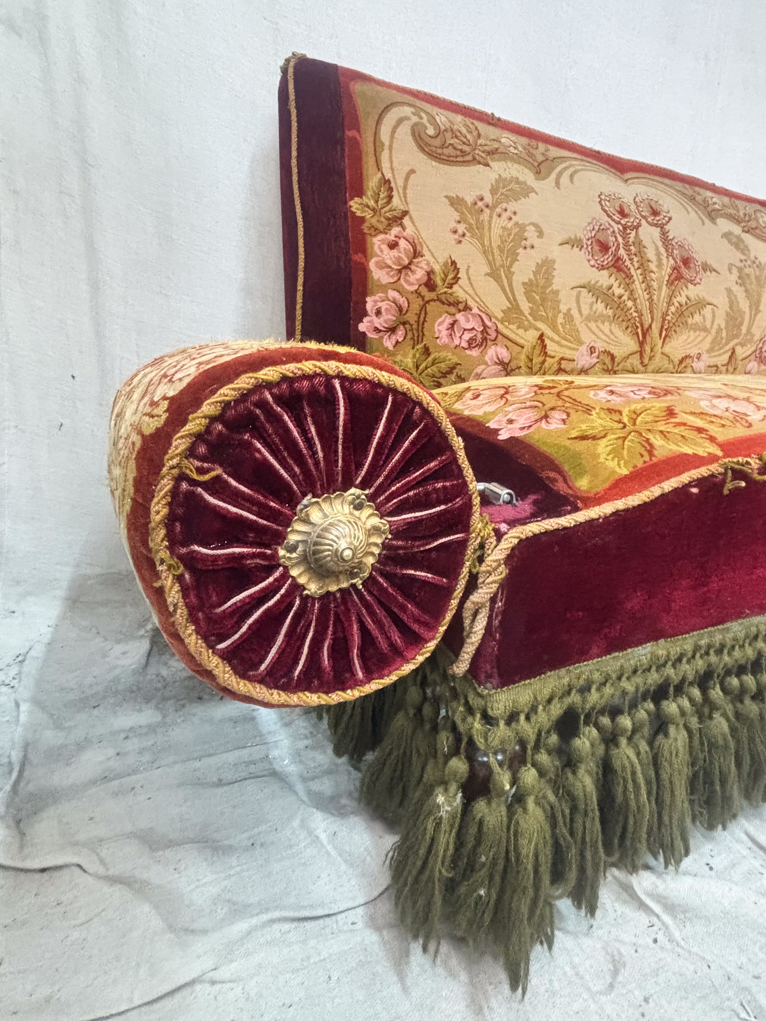 Decorative pillow with intricate patterns and tassels on a white background