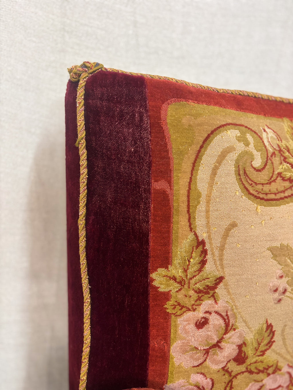Close-up of a decorative pillow with floral patterns on a plain background