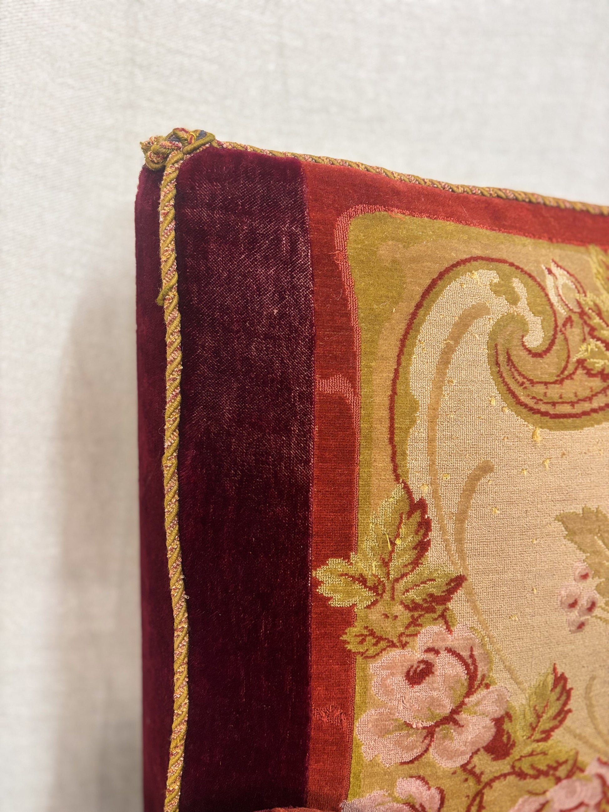 Close-up of a decorative pillow with floral patterns on a plain background