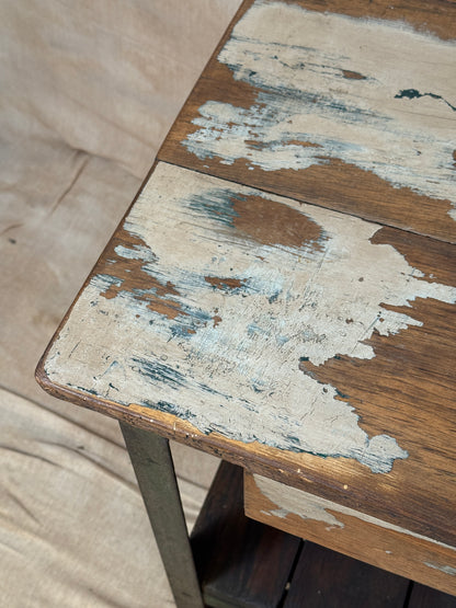 A rustic industrial wooden and metal table.