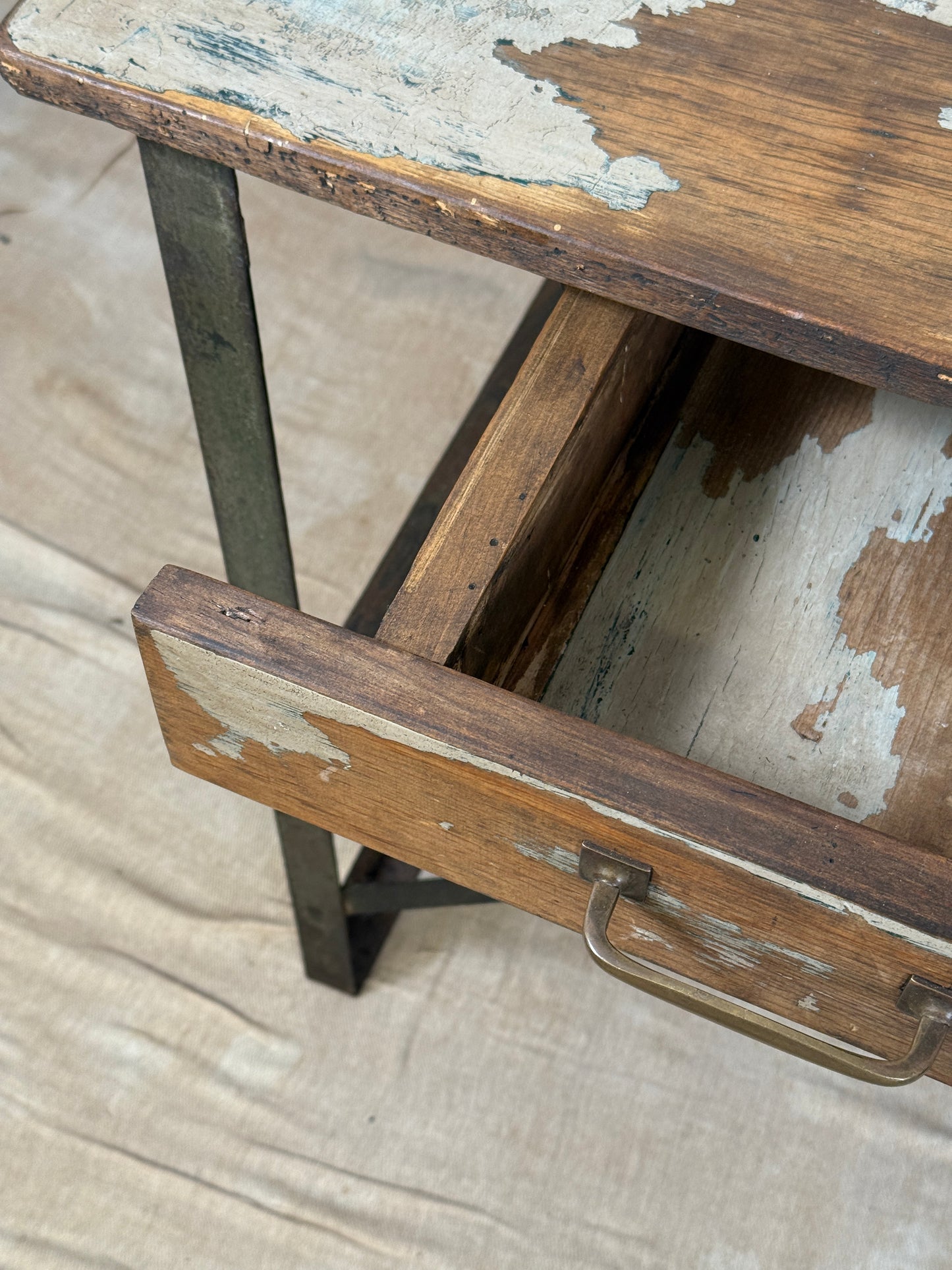 A rustic industrial wooden and metal table.