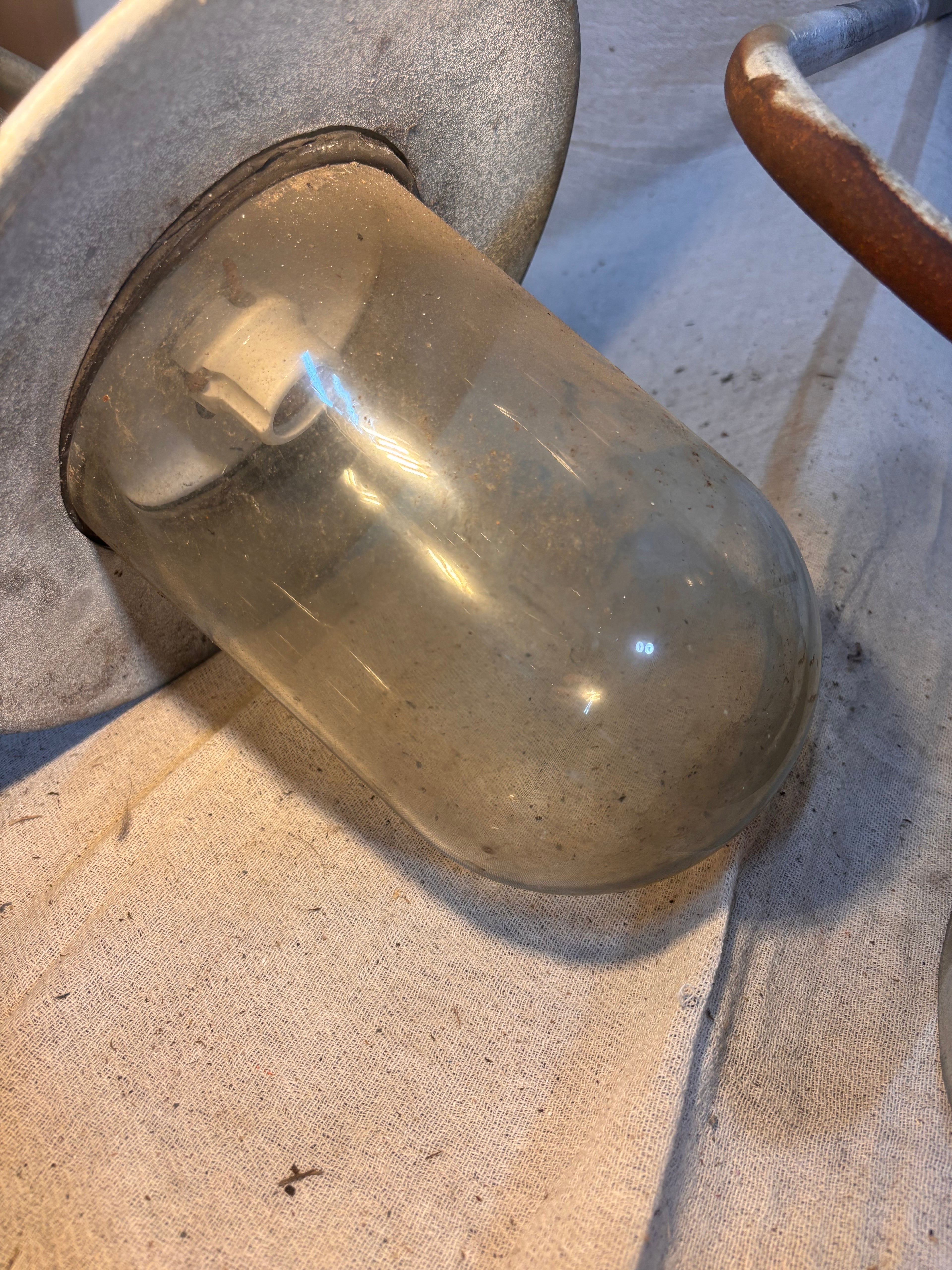 Large glass light bulb cover on a cloth floor