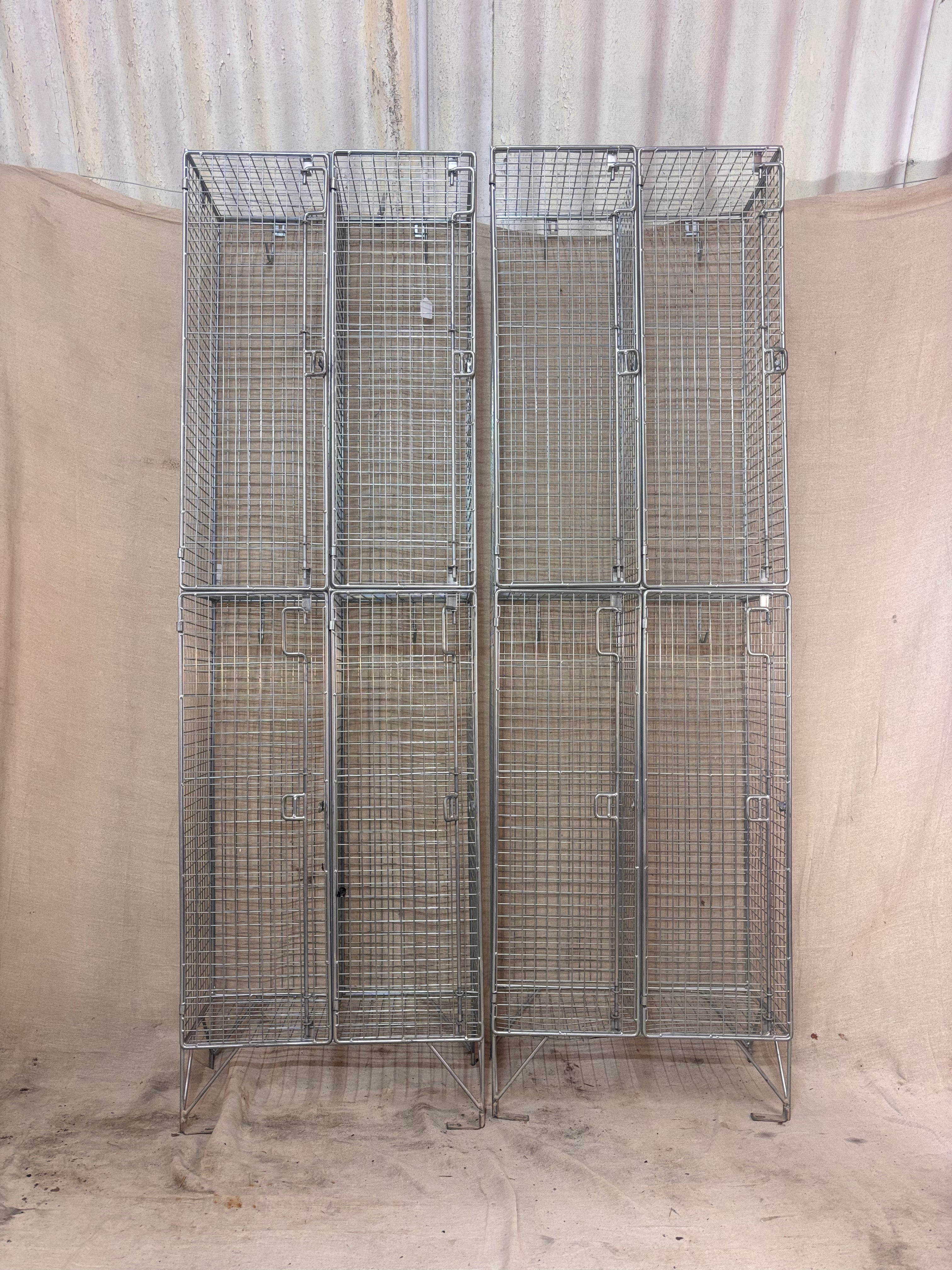 Metal wire storage lockers against a plain background