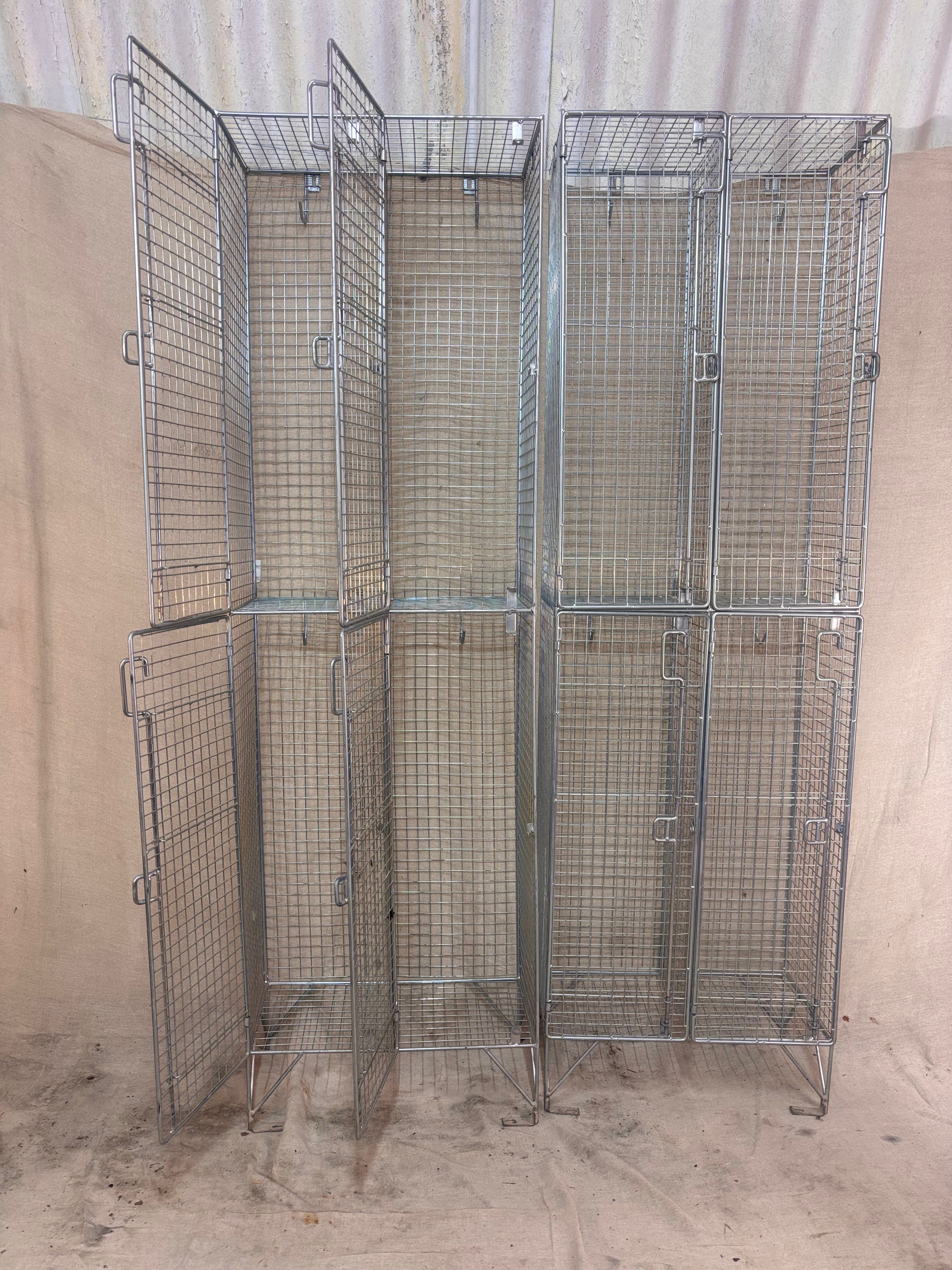 Set of metal wire storage cages against a beige wall.