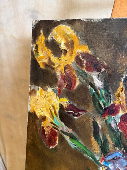 A close-up of an oil painting depicting yellow irises with textured brushstrokes in yellow, red, green, and dark brown tones.