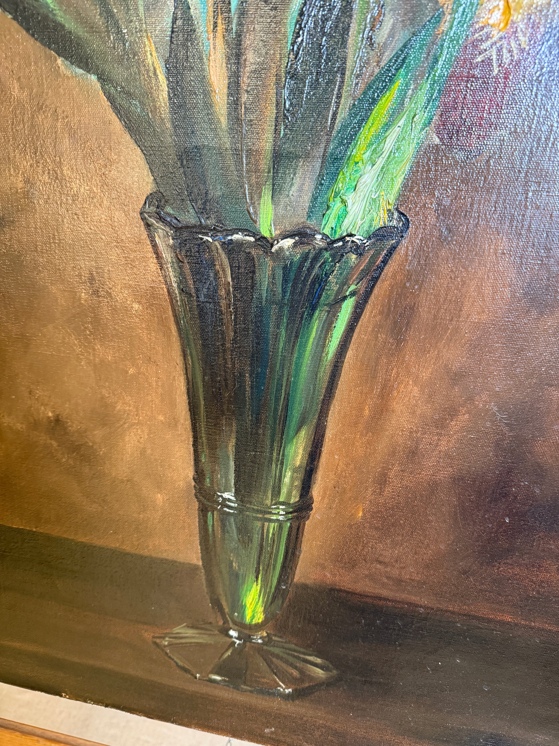 A close-up of a painted still life showing a translucent green glass vase with a flared rim, filled with leafy stems, against a brown painterly background.