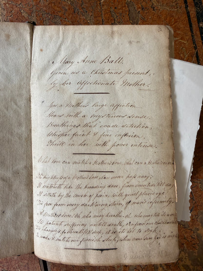 Old document with handwritten text on a wooden surface