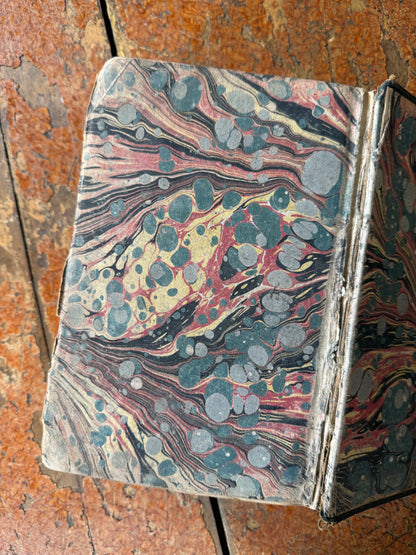Marbled antique book on a textured surface