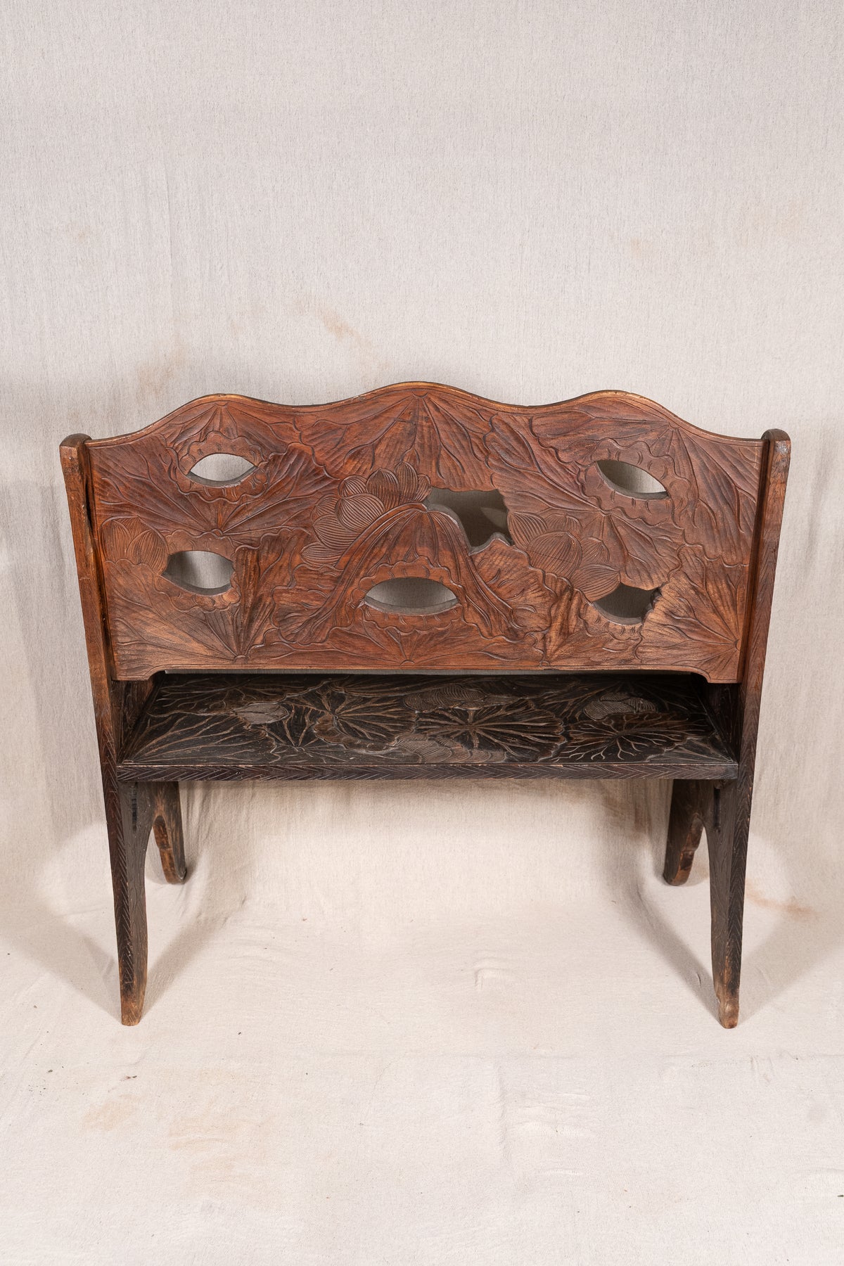 Liberty & Co. Japanese carved hardwood bench, circa 1900–1910, featuring pierced floral panels and intricate decoration from the Arts and Crafts period.