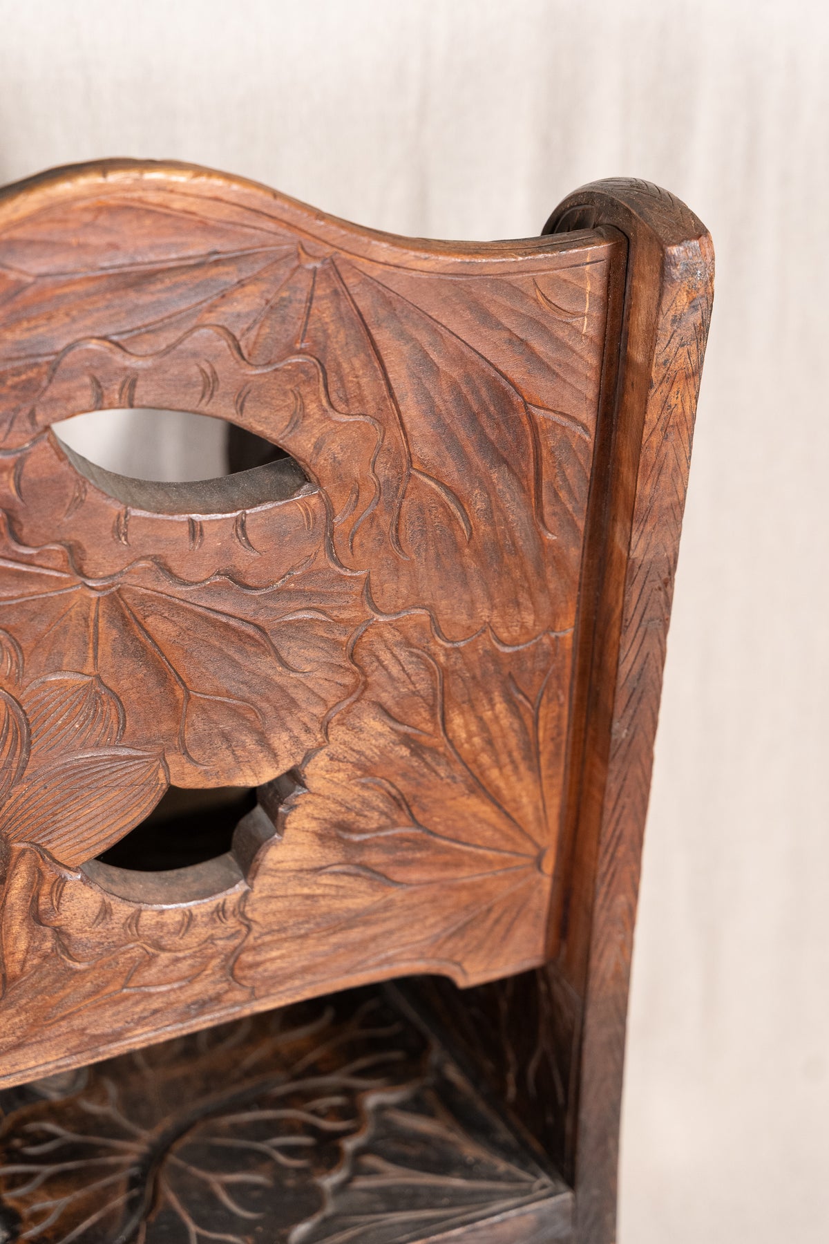 Liberty & Co. Japanese carved hardwood bench, circa 1900–1910, featuring pierced floral panels and intricate decoration from the Arts and Crafts period.
