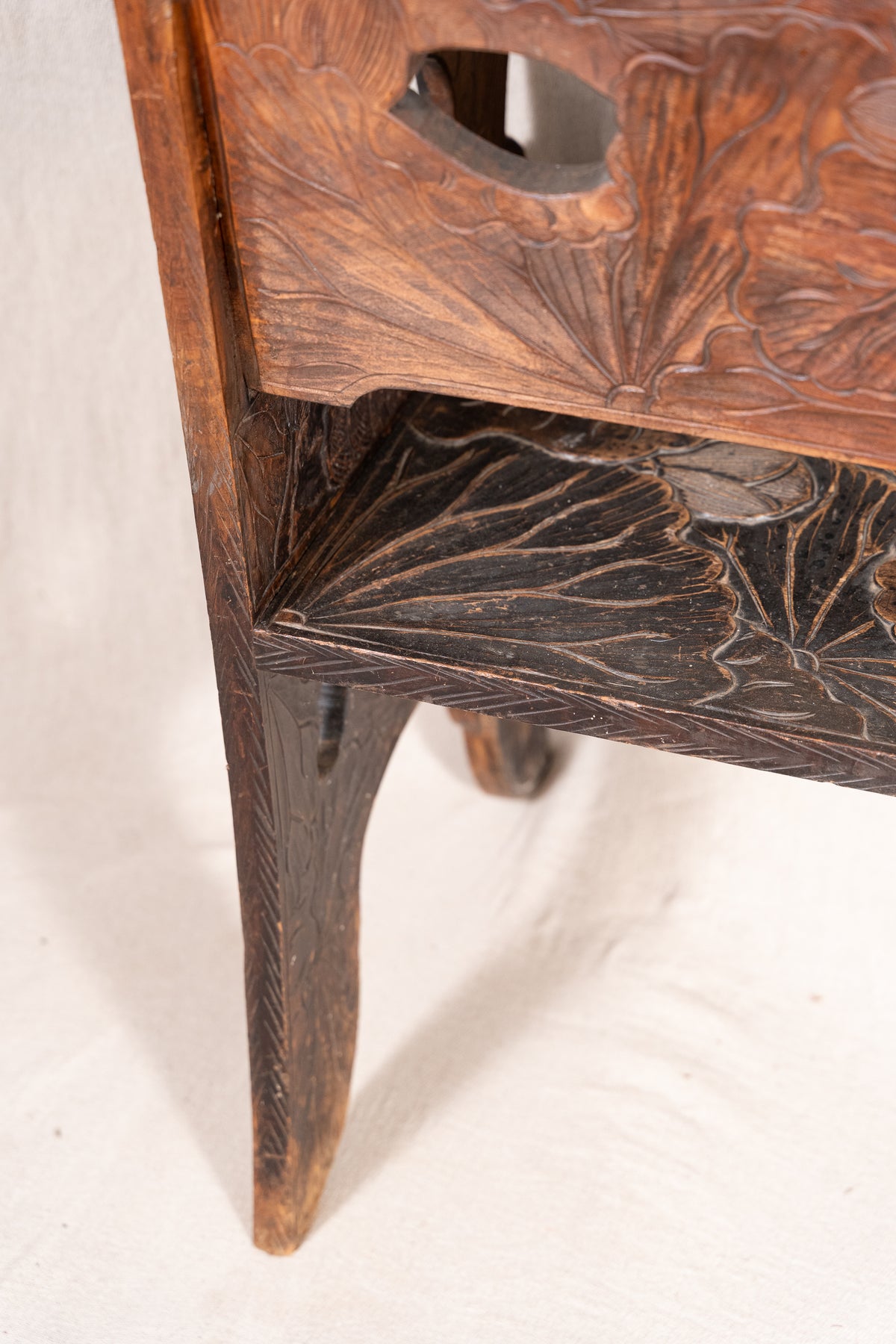 Liberty & Co. Japanese carved hardwood bench, circa 1900–1910, featuring pierced floral panels and intricate decoration from the Arts and Crafts period.