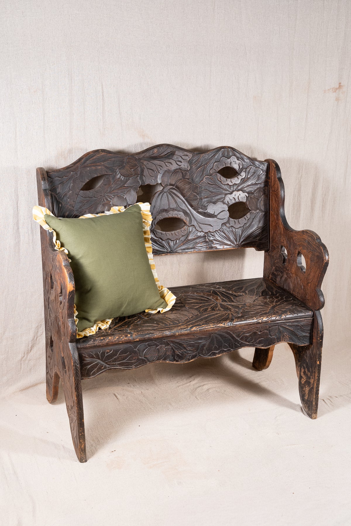 Liberty & Co. Japanese carved hardwood bench, circa 1900–1910, featuring pierced floral panels and intricate decoration from the Arts and Crafts period.
