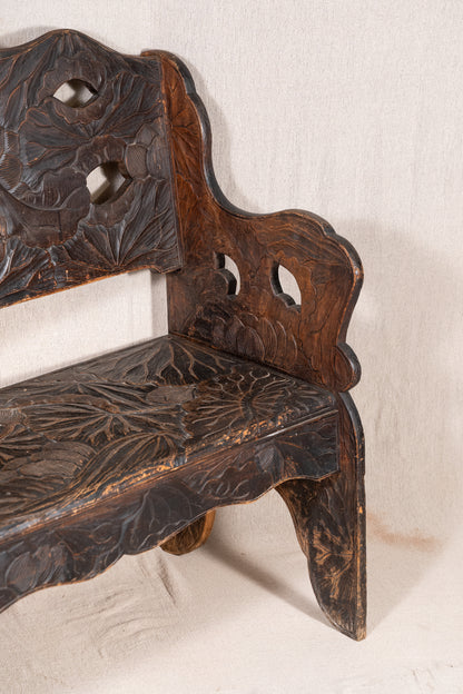 Liberty & Co. Japanese carved hardwood bench, circa 1900–1910, featuring pierced floral panels and intricate decoration from the Arts and Crafts period.
