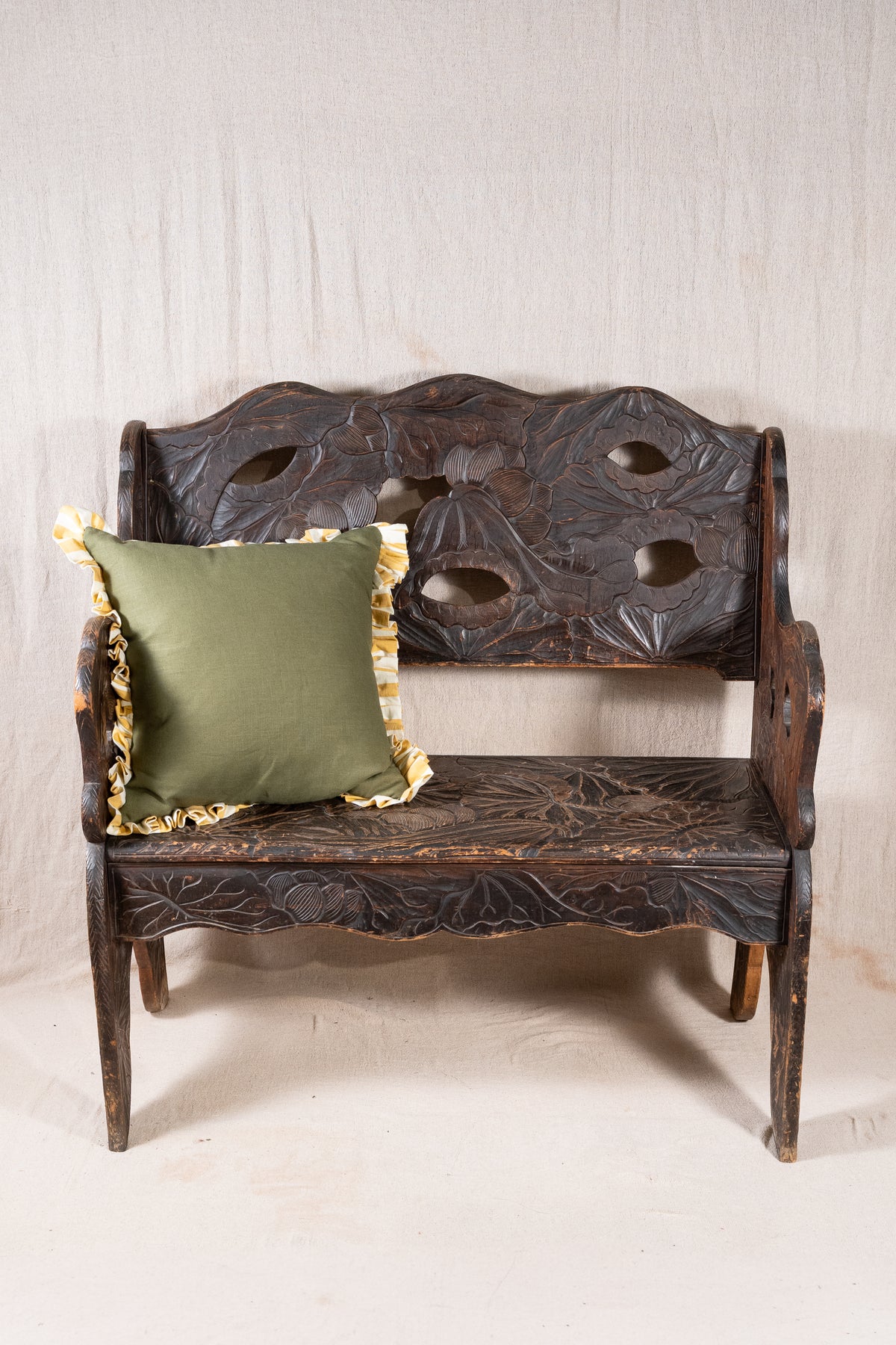 Liberty & Co. Japanese carved hardwood bench, circa 1900–1910, featuring pierced floral panels and intricate decoration from the Arts and Crafts period.
