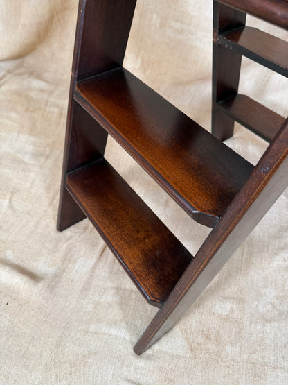 Wooden Library Steps on a textured beige surface