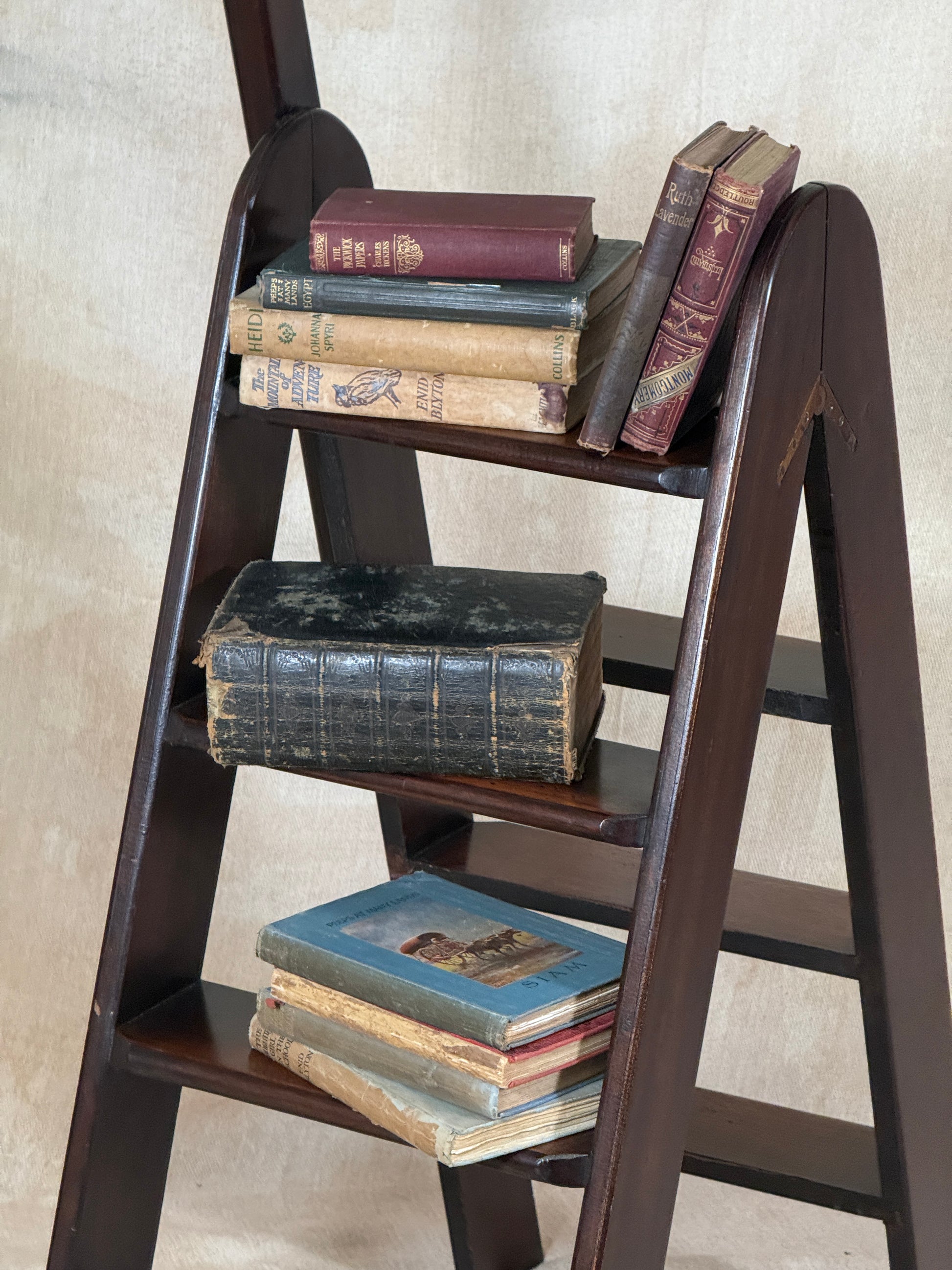 Wooden Library Steps on a textured beige surface