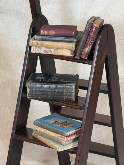 Wooden Library Steps on a textured beige surface