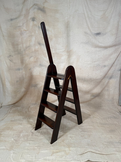 Wooden step ladder on a textured beige background
