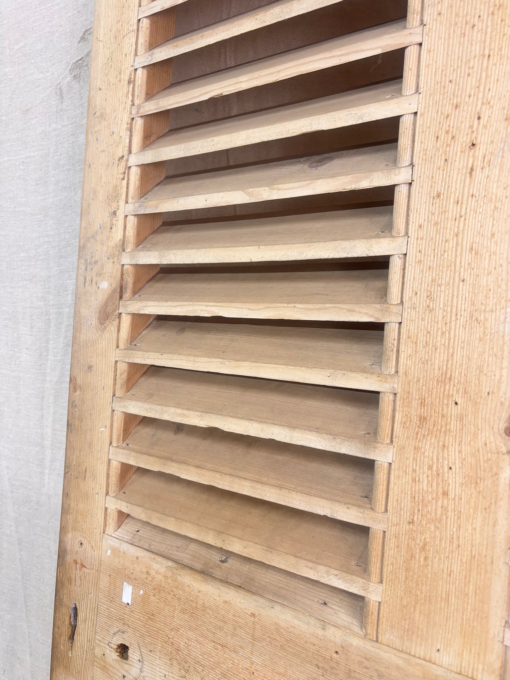 a Wooden Louvered Door against a cream backdrop