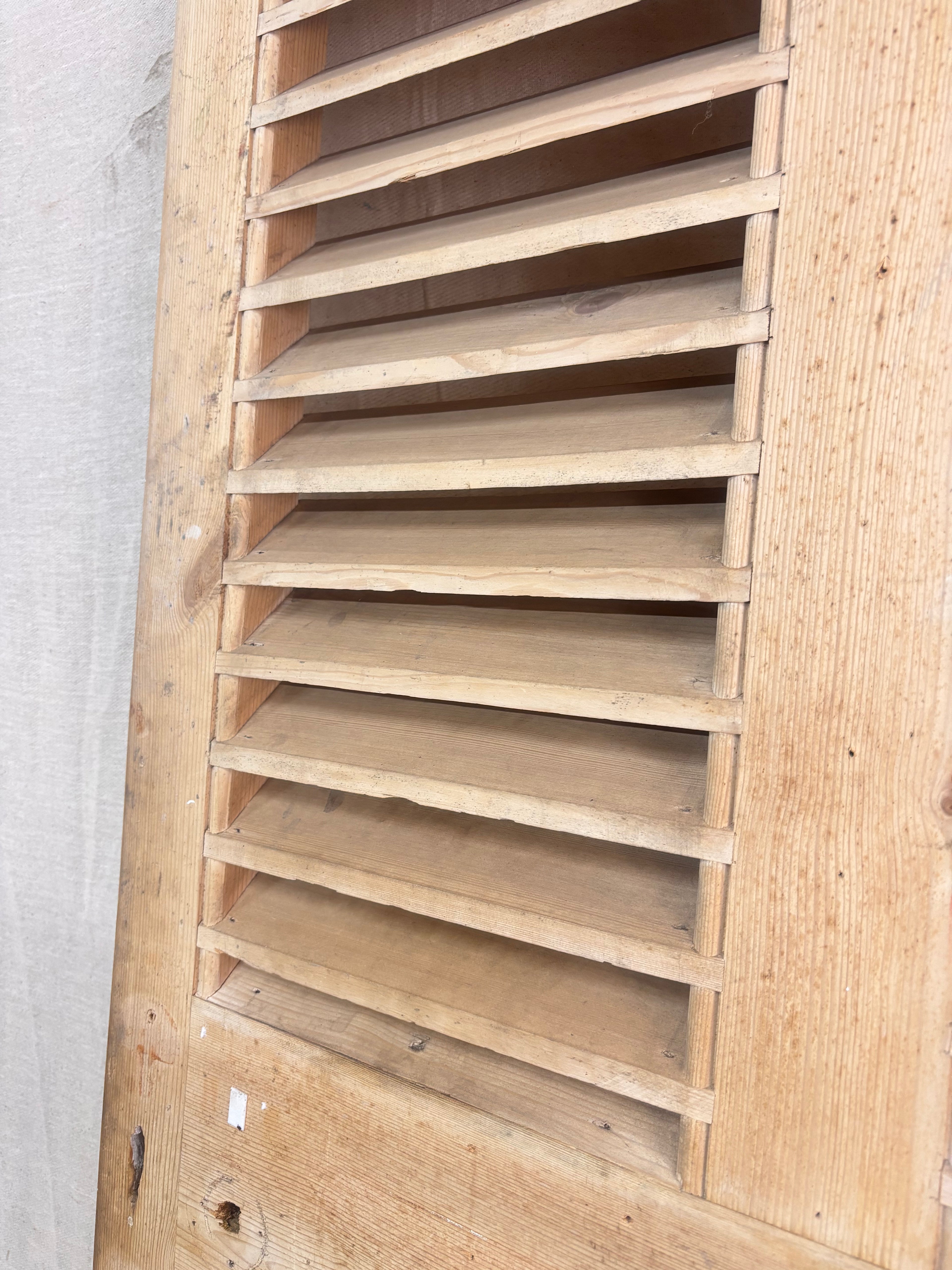 a Wooden Louvered Door against a cream backdrop