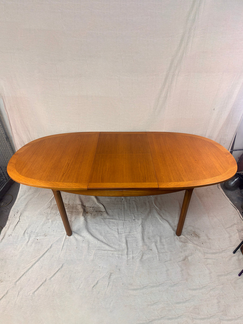 an extended dining table on a white cloth background