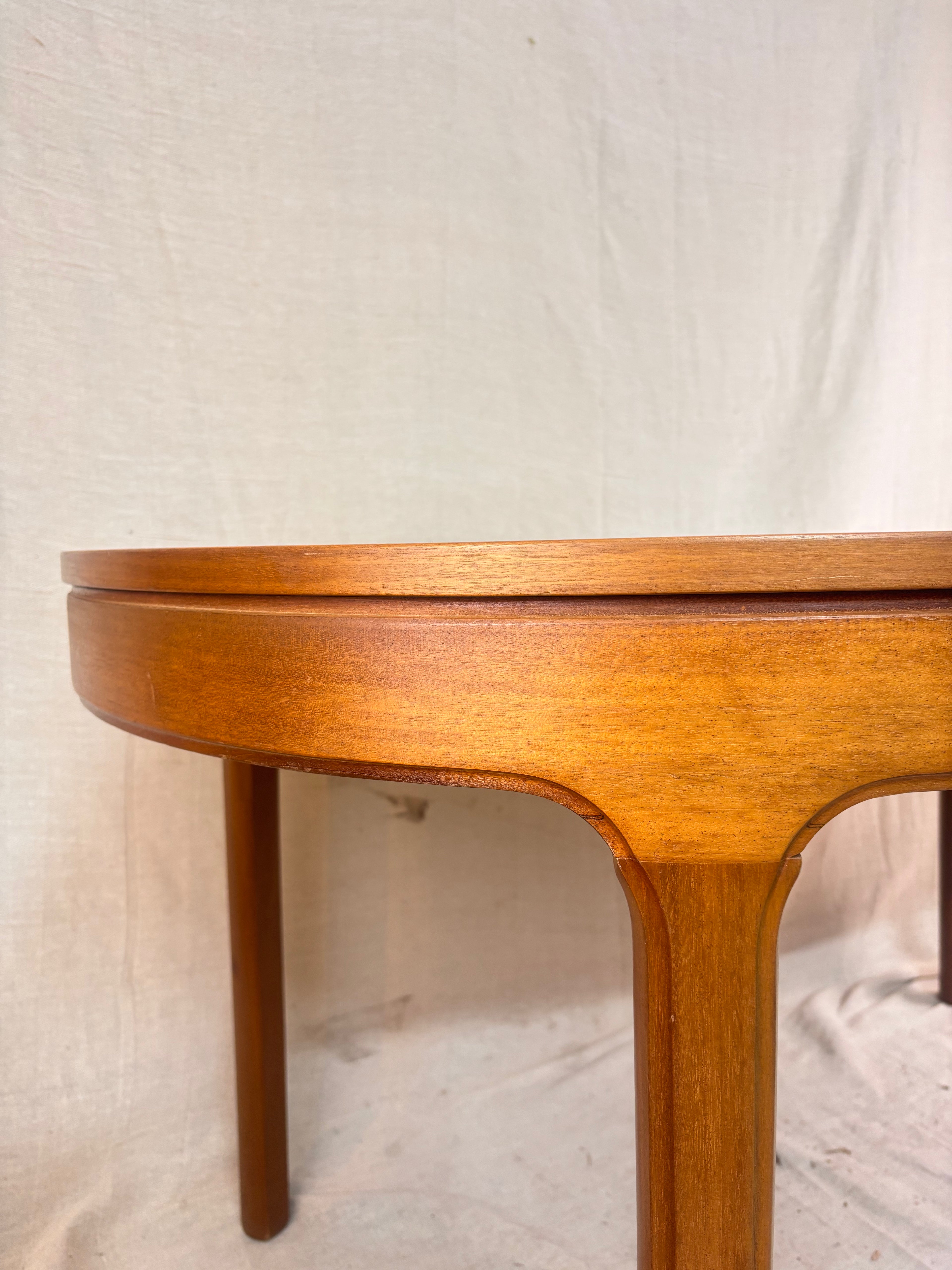 Close up detail of wooden dining table on cloth background