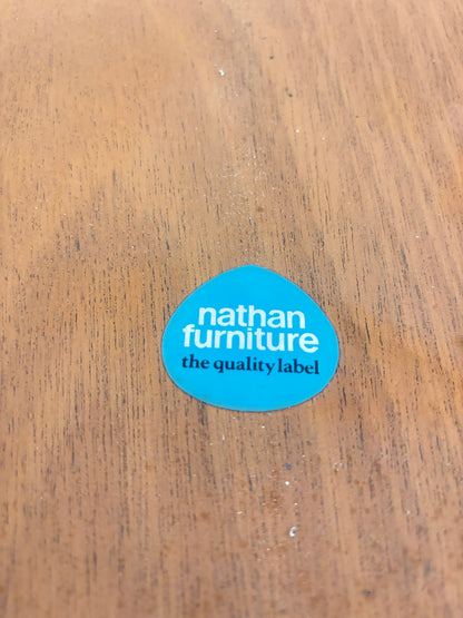 a blue sticker on a wooden surface nathan furniture the quality label