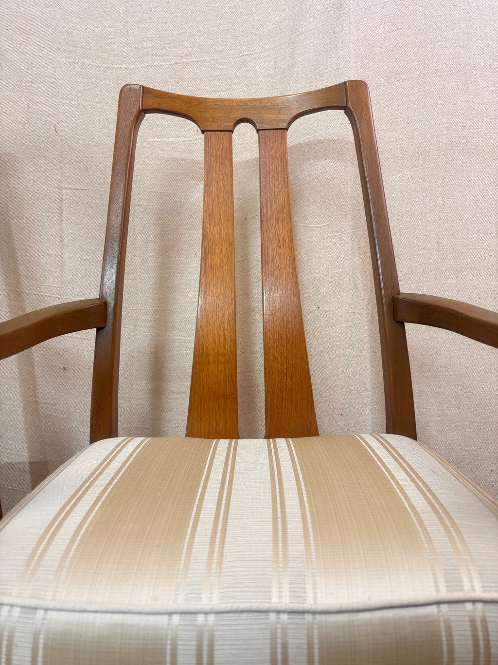 close up of a carer dining chair against a light coloured wall