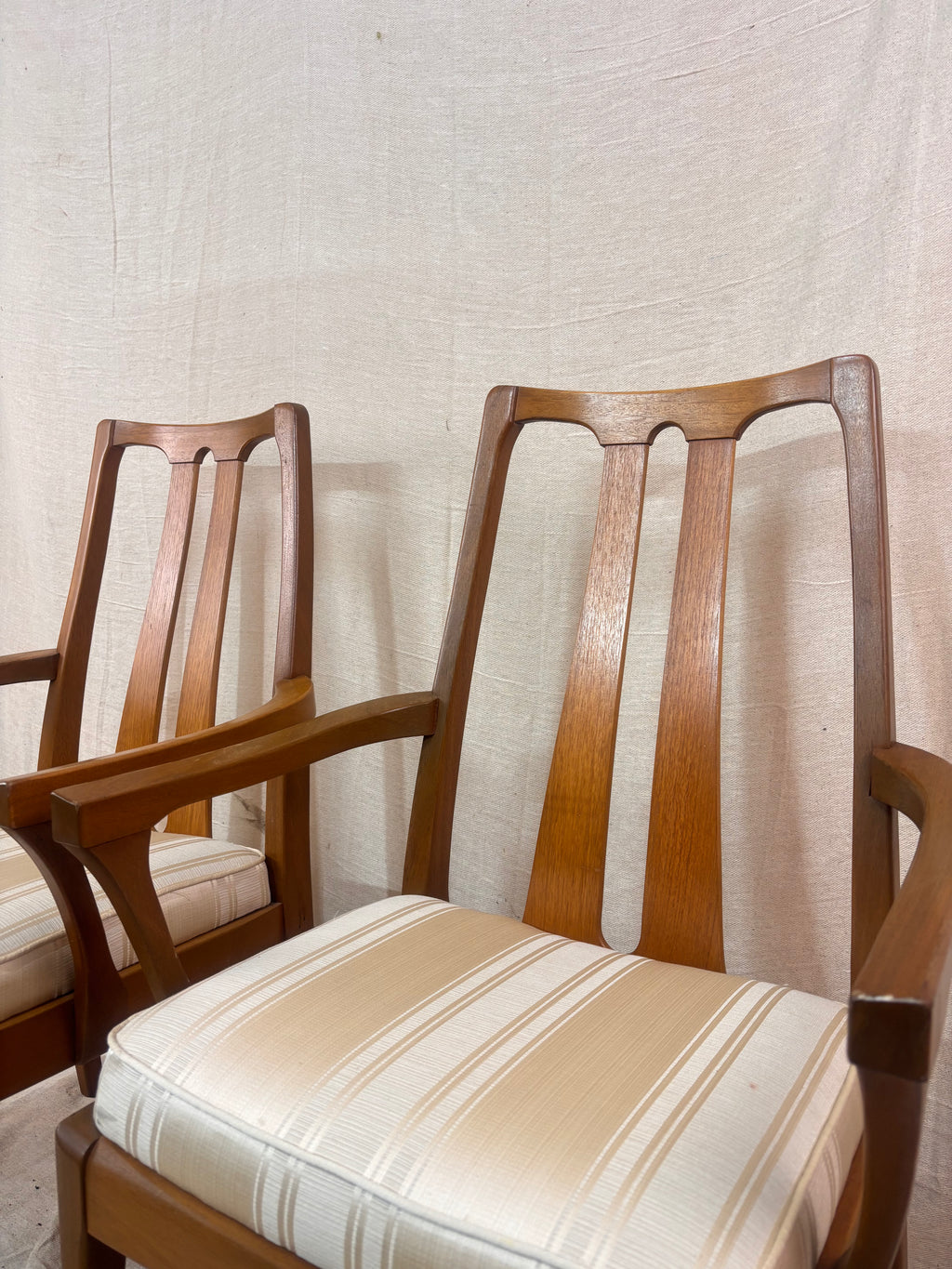 pair of carver style dining chairs next to a light coloured wall