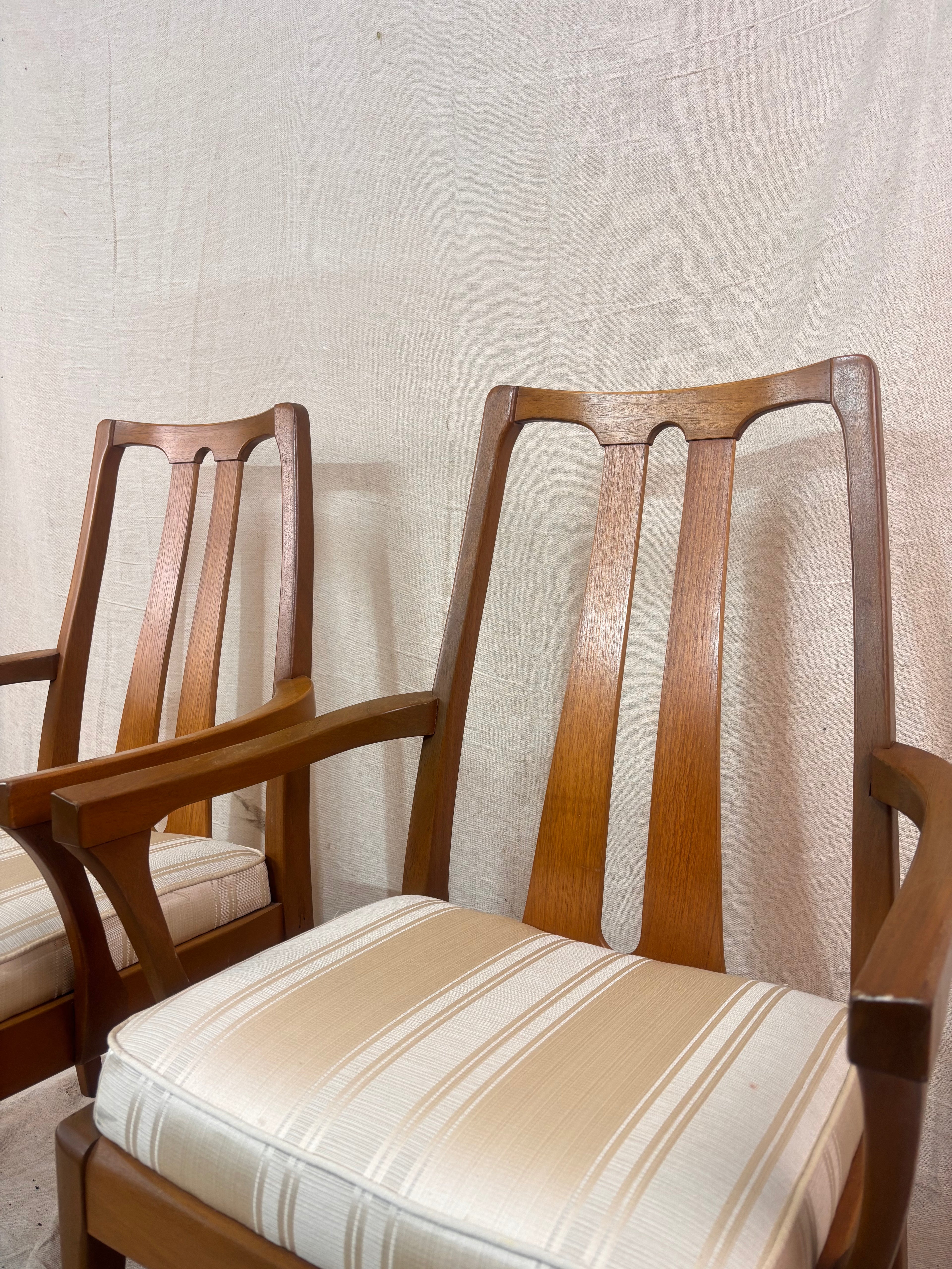 pair of carver style dining chairs next to a light coloured wall