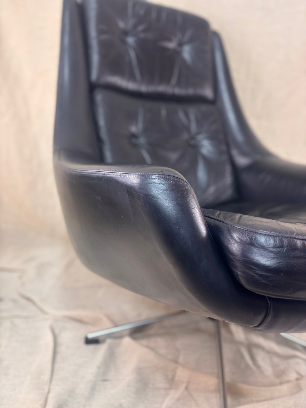 Black leather chair on a beige carpet