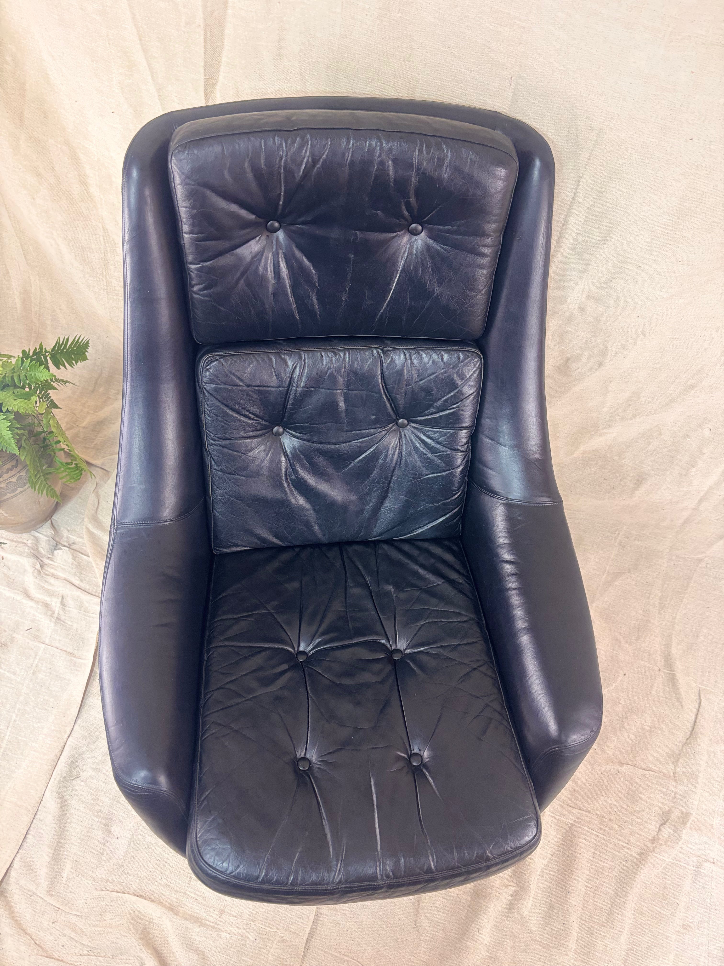 black leather armchair on a beige surface