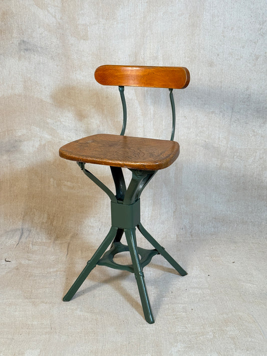 Vintage industrial machinist chair with green steel frame, wooden seat. 