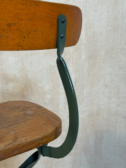Vintage industrial machinist chair with green steel frame, wooden seat. 