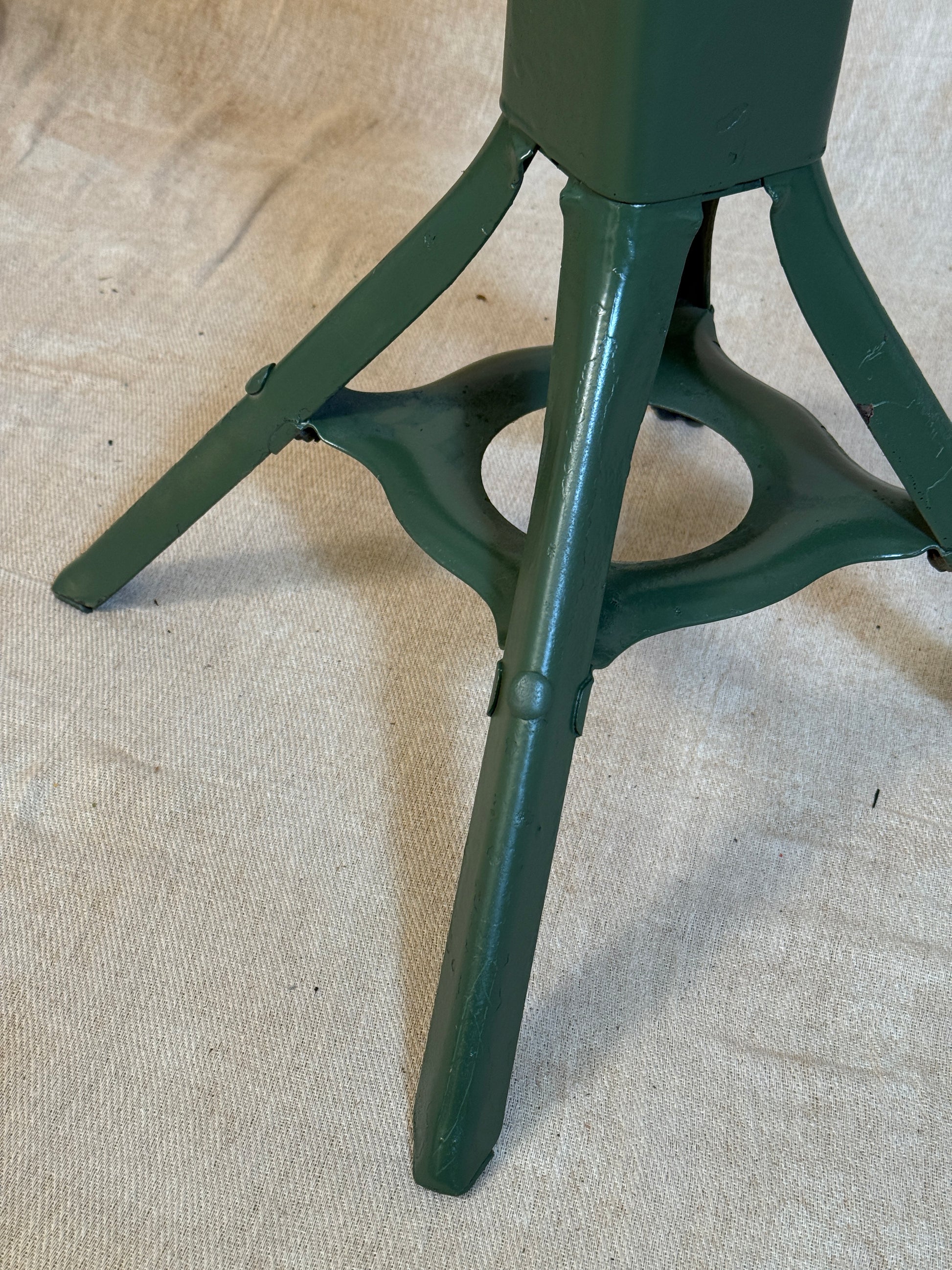 Vintage industrial machinist chair with green steel frame, wooden seat. 