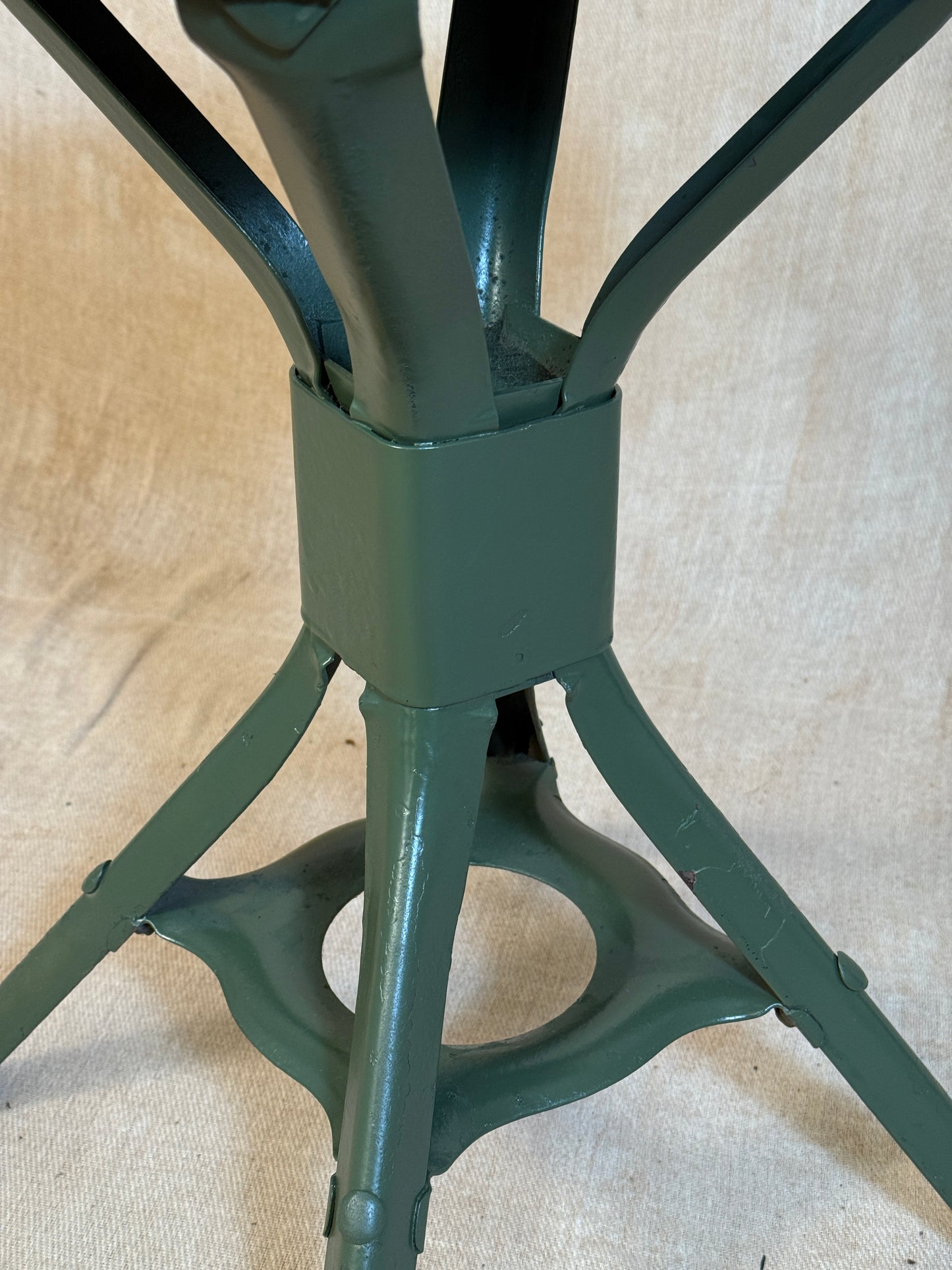 Vintage industrial machinist chair with green steel frame, wooden seat. 