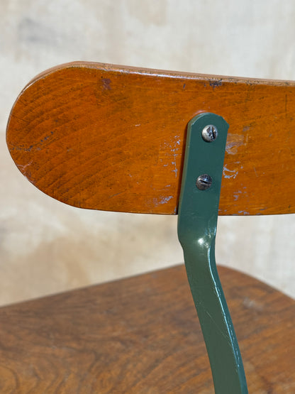 Vintage industrial machinist chair with green steel frame, wooden seat. 