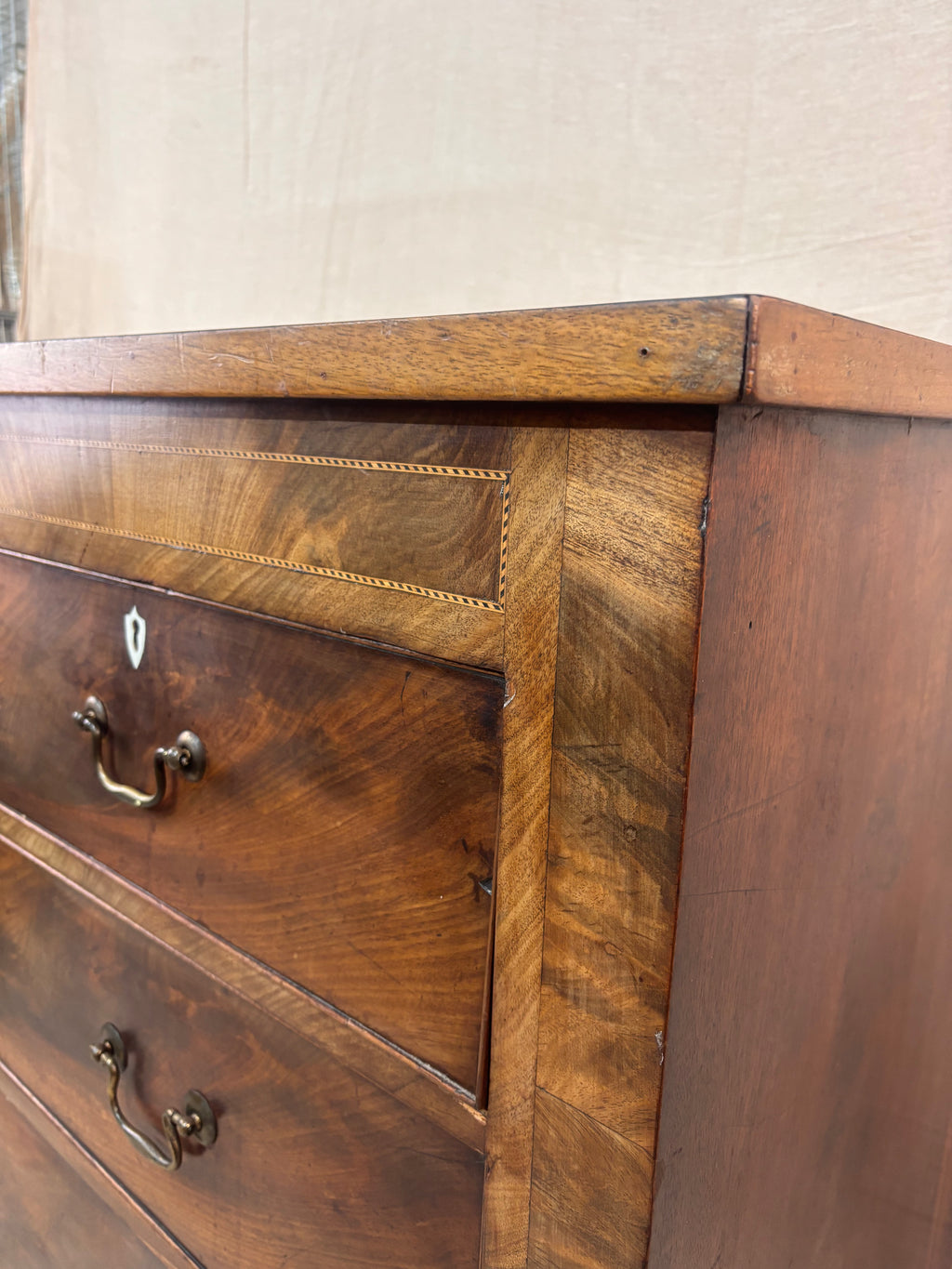 Close-up of a wooden dresser with visible grain and texture.