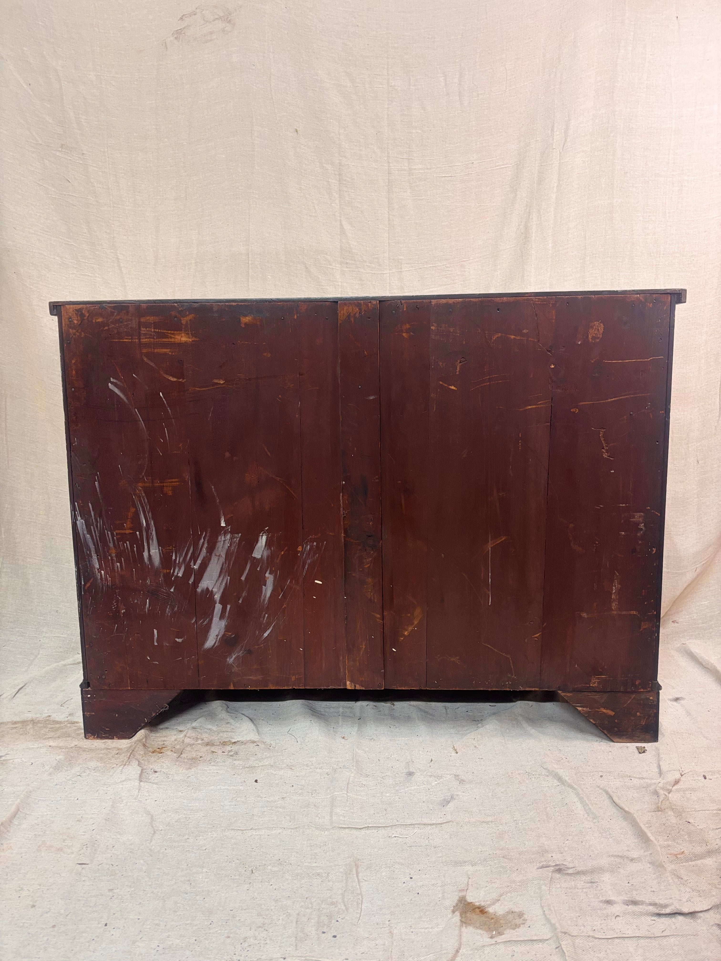 Vintage wooden cabinet with a distressed finish on a plain background