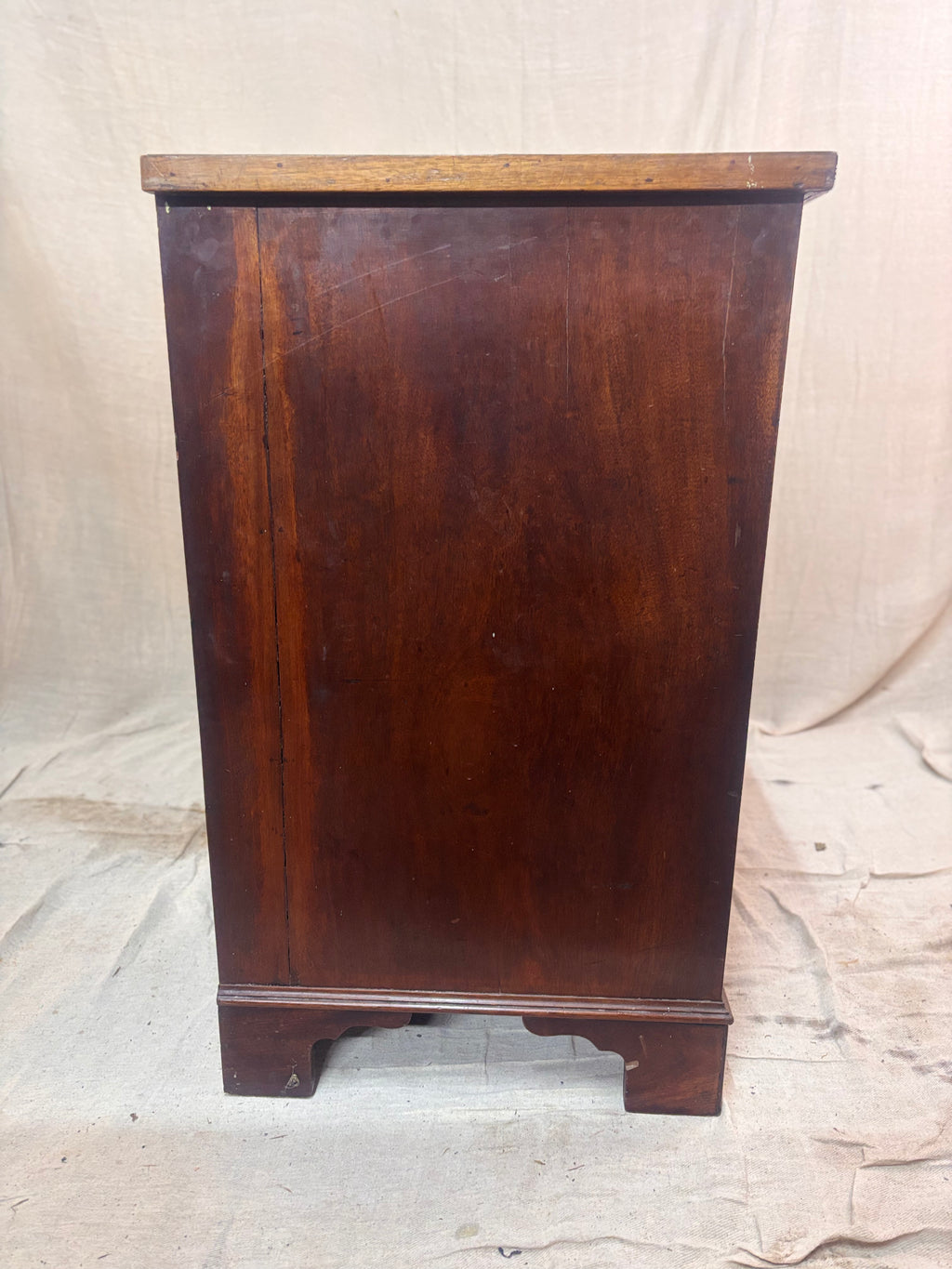 Wooden cabinet with a dark brown finish on a light background